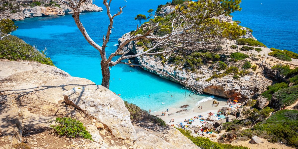 Calo des Moro beach, Mallorca, spain on a sunny day with people on the beach